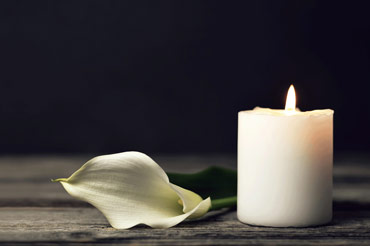 Candle with white rose petal